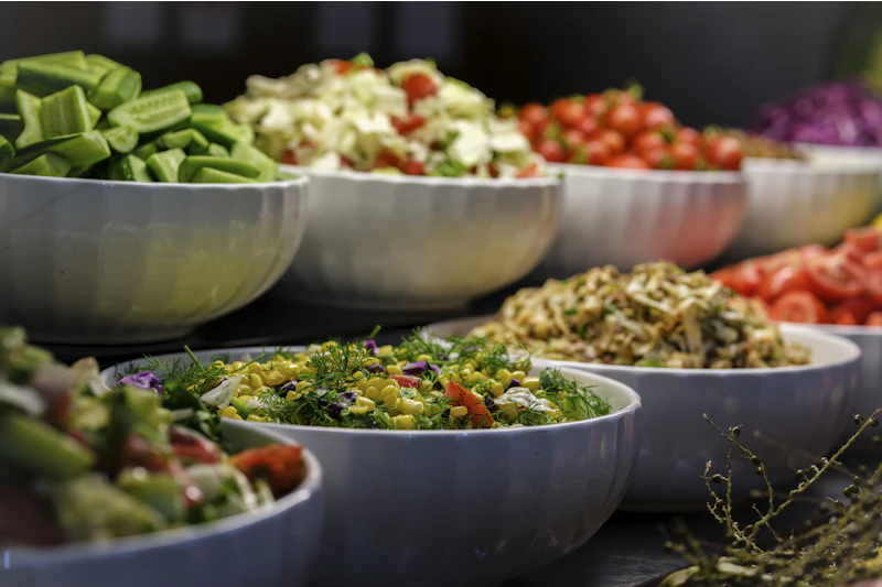 Healthy salad buffet in serving bowls at a catered event in New York City