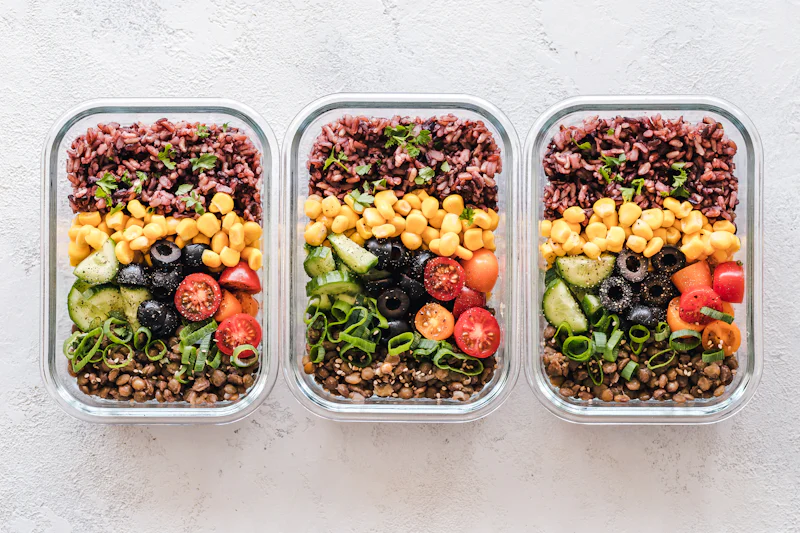 Individually packed healthy boxed lunches with grains, lentils and vegetables