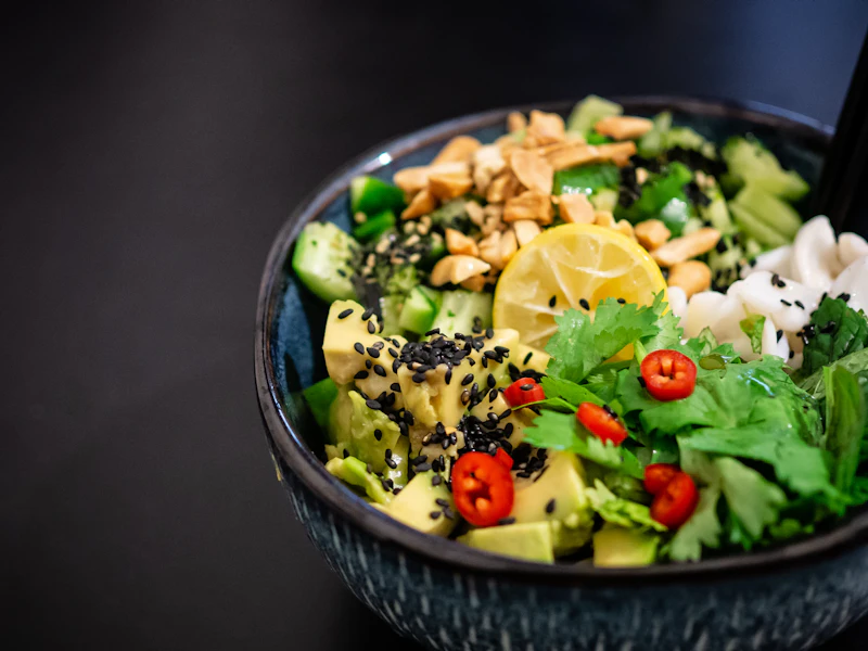 Vegan vegetable salad bowl with greens, tomatoes and citrus
